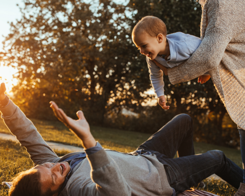 Happy parents embracing parenthood later in life, reflecting modern family trends